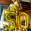 Thumbnail: Medium sized balloon arrangement. Base color: gold. golden heart and balloon number 50
