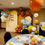 Thumbnail: Small balloon dining table centerpiece. Orange, yellow, blue and white colors.