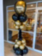 Thumbnail: Bland and gold balloon bone-shaped pillar with a big "ignite gala" balloon on top