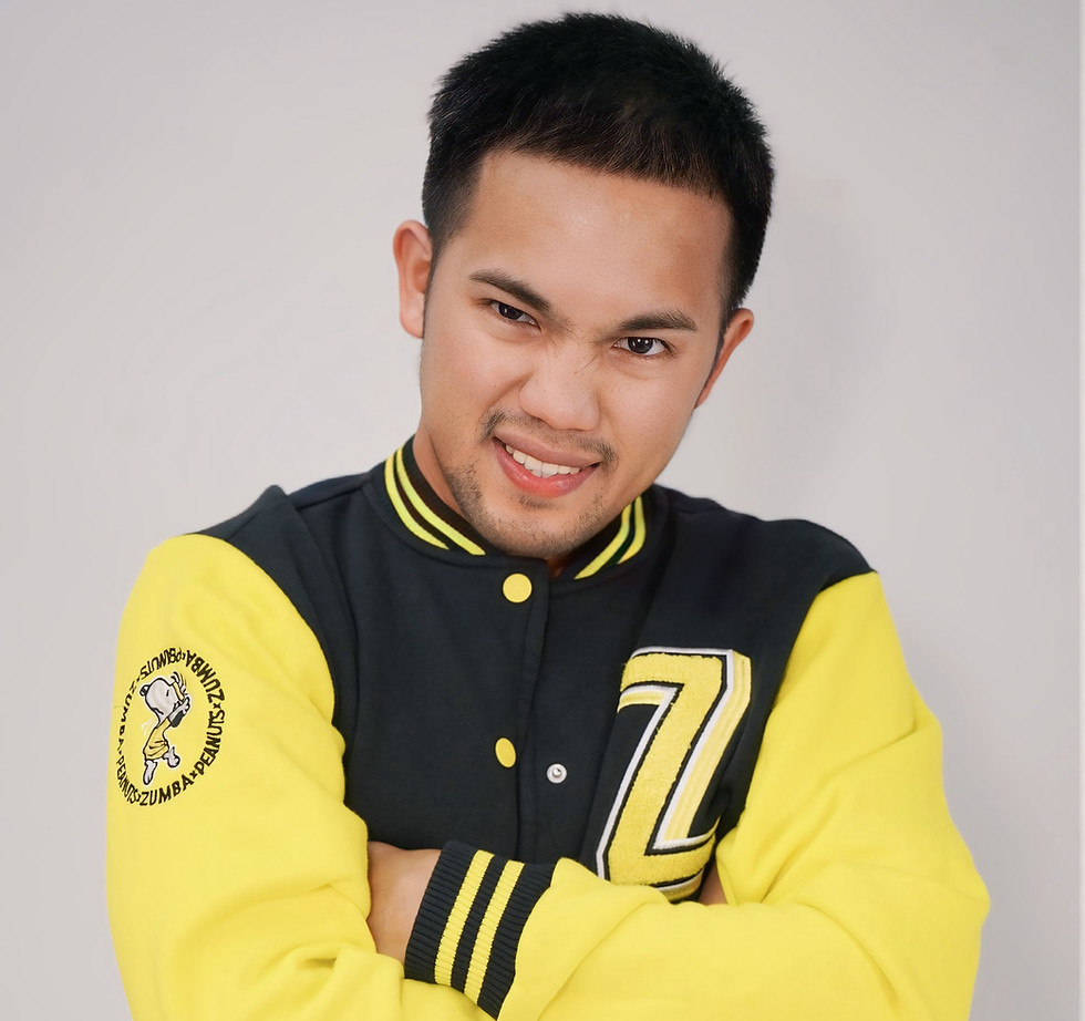 Man smiling in a yellow and black varsity jacket