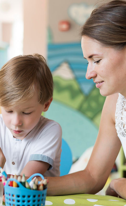 medium-shot-teacher-kid-painting (1).jpg