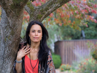 beautiful-dark-haired-woman-compassionate-deep-eyes-leaning-on-tree