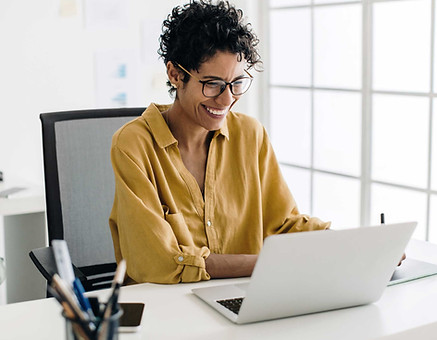 AdobeStock_629603534-black-woman-computer-happy-engaged-smiling-sfw_edited.jpg