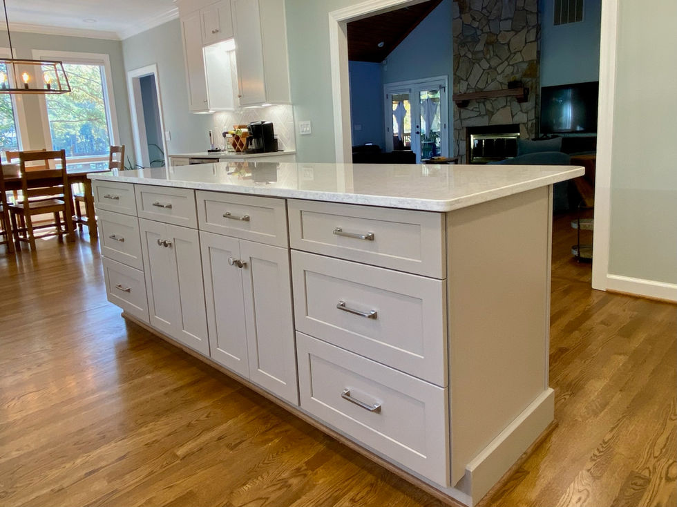 White kitchen island with drawers, cabinets, and countertop; ESC Cabinets.