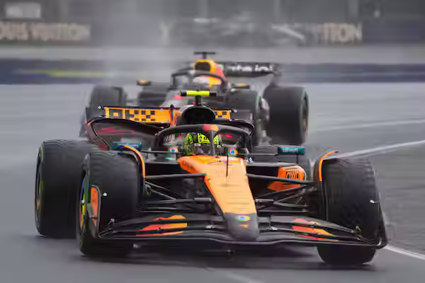 Lando Norris leading the Australian Grand Prix ahead of reigning F1 Champion Max Verstappen. (Photo by Scott Barbour/The Associated Press)