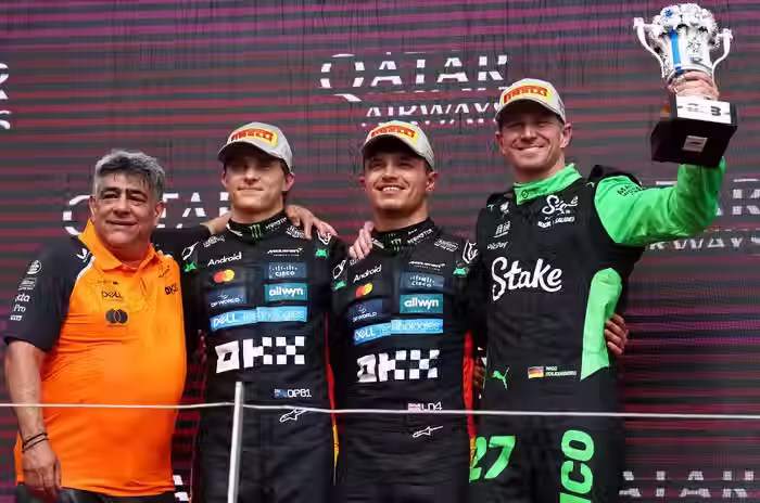 McLaren team member (far left), Oscar Piastri (left), Lando Norris (right), and Nico Hulkenberg (far right) celebrate on top of the podium at the British Grand Prix (Photo by: Autocar India)
