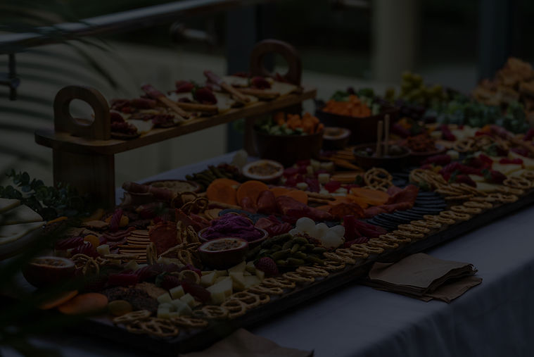 Elegant grazing table with artisan cheeses, cured meats, fruit and antipasto