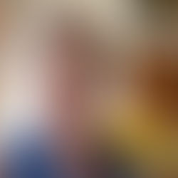 Life coach smiling happily at home with sunflowers in the background