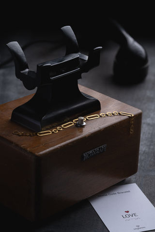 Antonis Karakonstantakis photographer based in Crete, jewelry photography with studio lighting, gold bracelet placed on vintage dictograph device, luxury product photography for jewelry brands and e-shop, branding image with storytelling concept, φωτογράφιση κοσμημάτων στην Κρήτη για κατάλογο και online shop με έμφαση στην προβολή και την εμπορική εικόνα