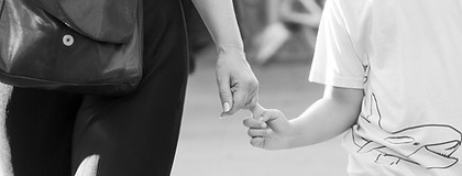 closeup to mother and child's hands while walking