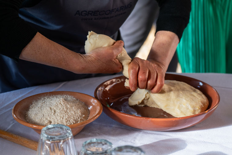 Close-up of hands shaping dough in a bowl during traditional food preparation, Antonis Karakonstantakis photographer, food process photography, artisanal cooking, dough texture, culinary detail, traditional recipe preparation, hands at work, gastronomy experience, authentic food making