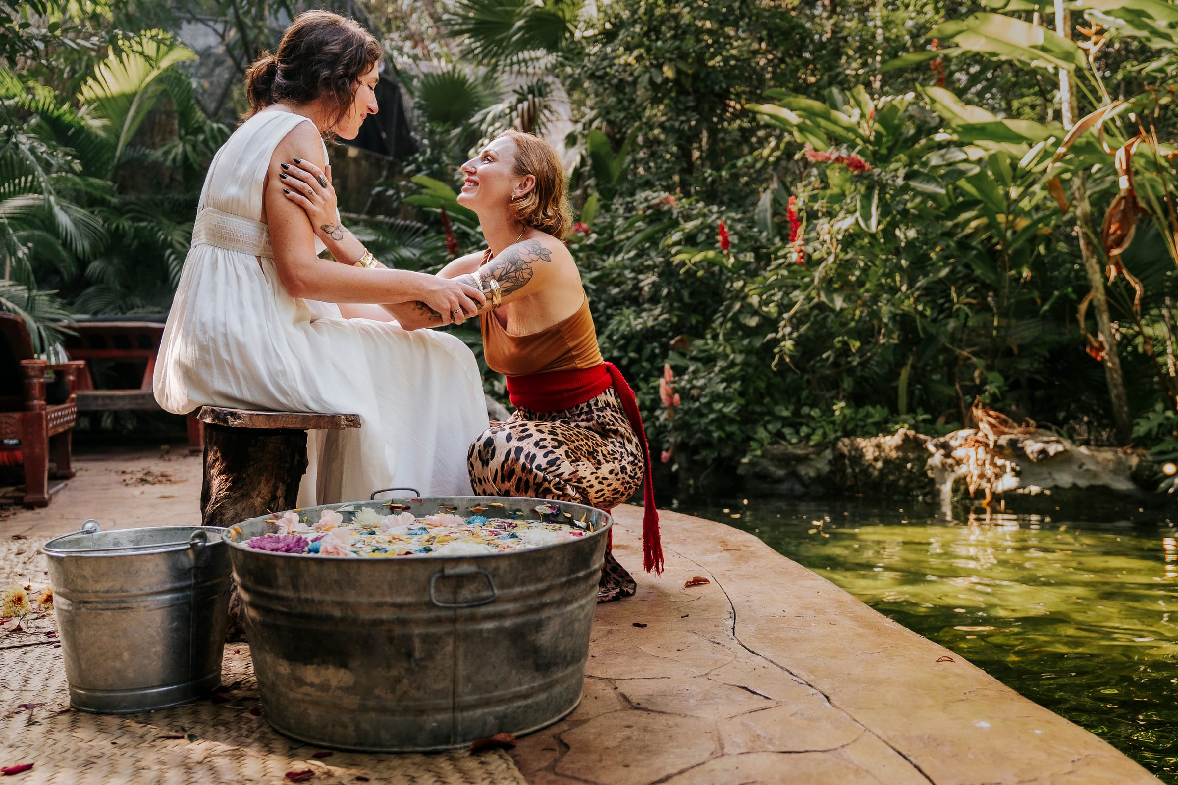 A flower water ritual beside the jungle pool at a REBÖRN retreat