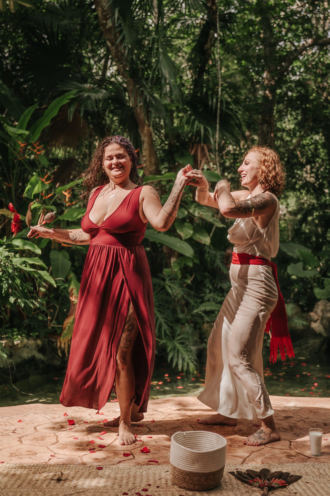 Two women dancing joyfully in the jungle