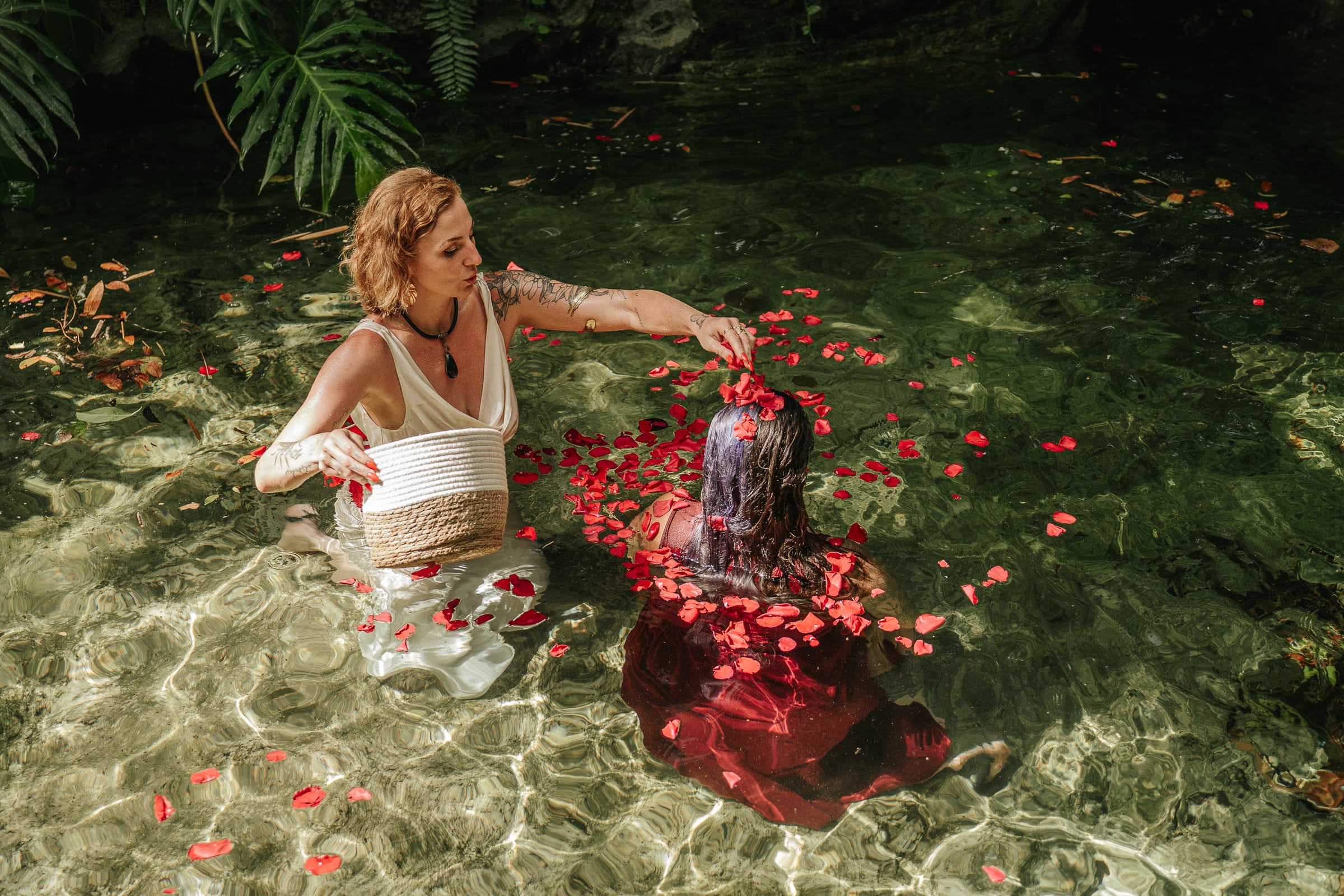 A jungle cenote ritual with red petals