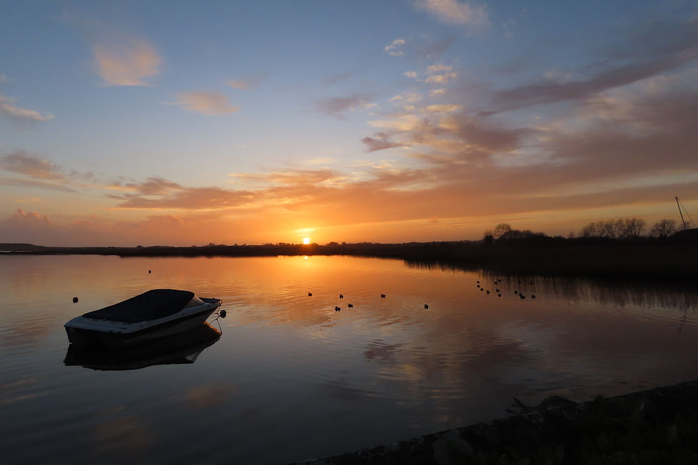 Image of a boat at sunset in Stanpit Marsh