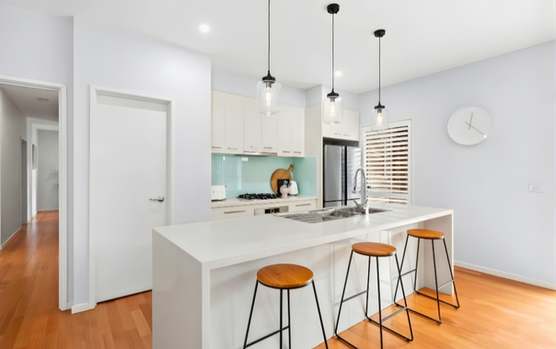 Modern kitchen with island bench, pendant lighting and timber flooring