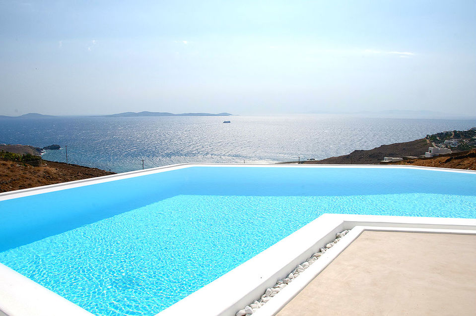 a large swimming pool with a view of the ocean