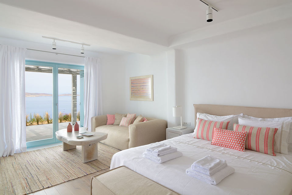 a bedroom with a large bed and a couch