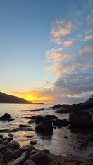 A different angle as the sun projects vibrant colors onto surrounding clouds