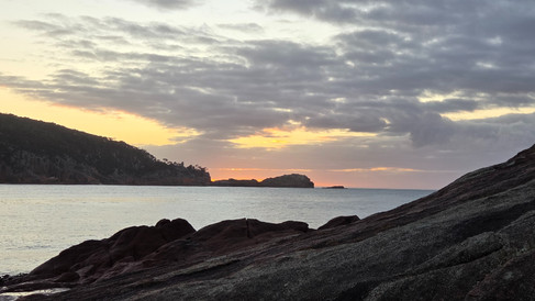 The faint beginning of the sunrise with soft colors on the horizon