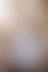 White communion dress from crystal and pearl boutique with mesh panelling, glass buttons and bow at the back