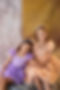 two girls wearing junior prom, P7 prom dresses. Girl on left wearing purple dress with floral detailing and girl on right wearing peach dress with floral detailing