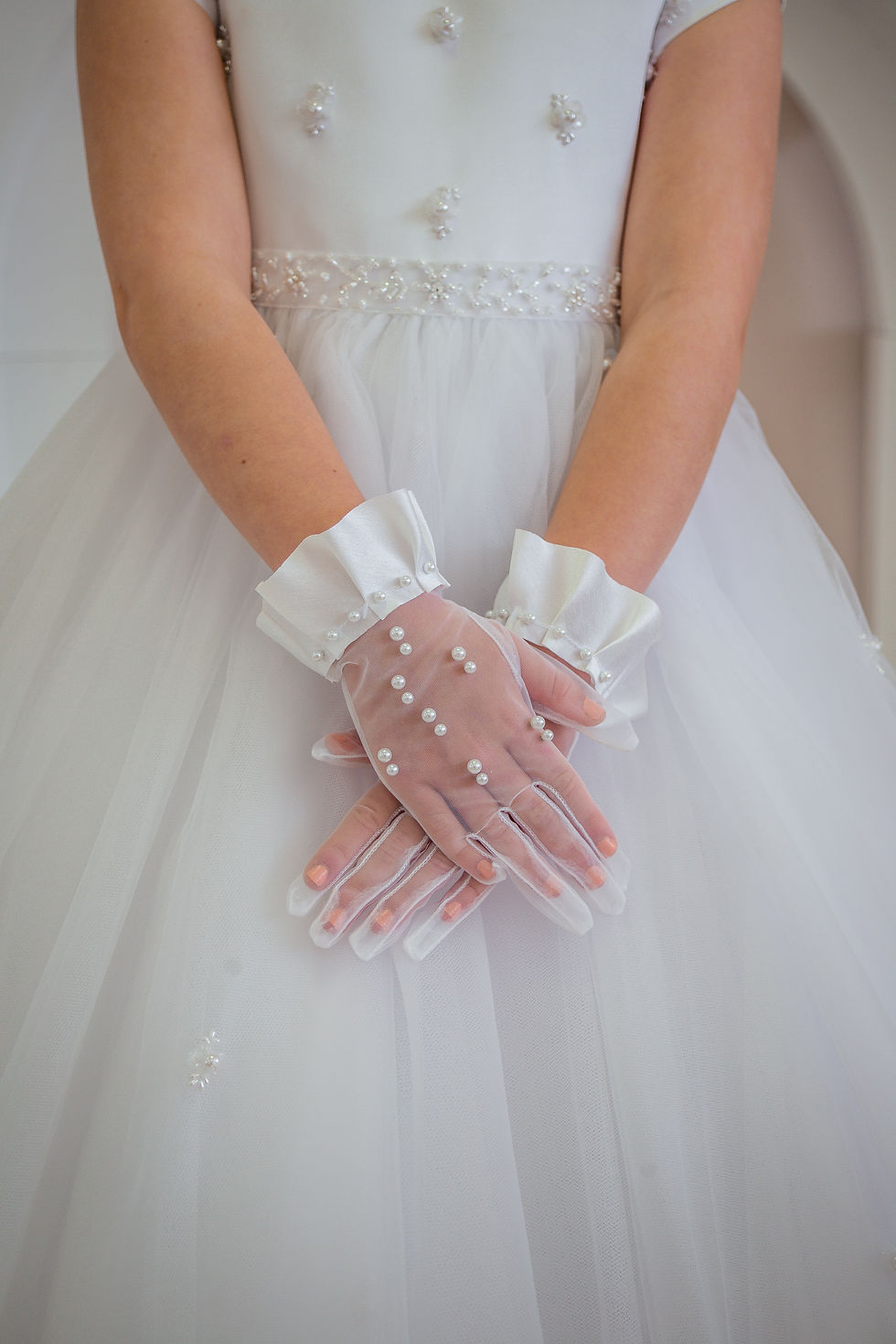 white mesh gloves with white satin ruffle wrist detailing with pearl detailing on the gloves