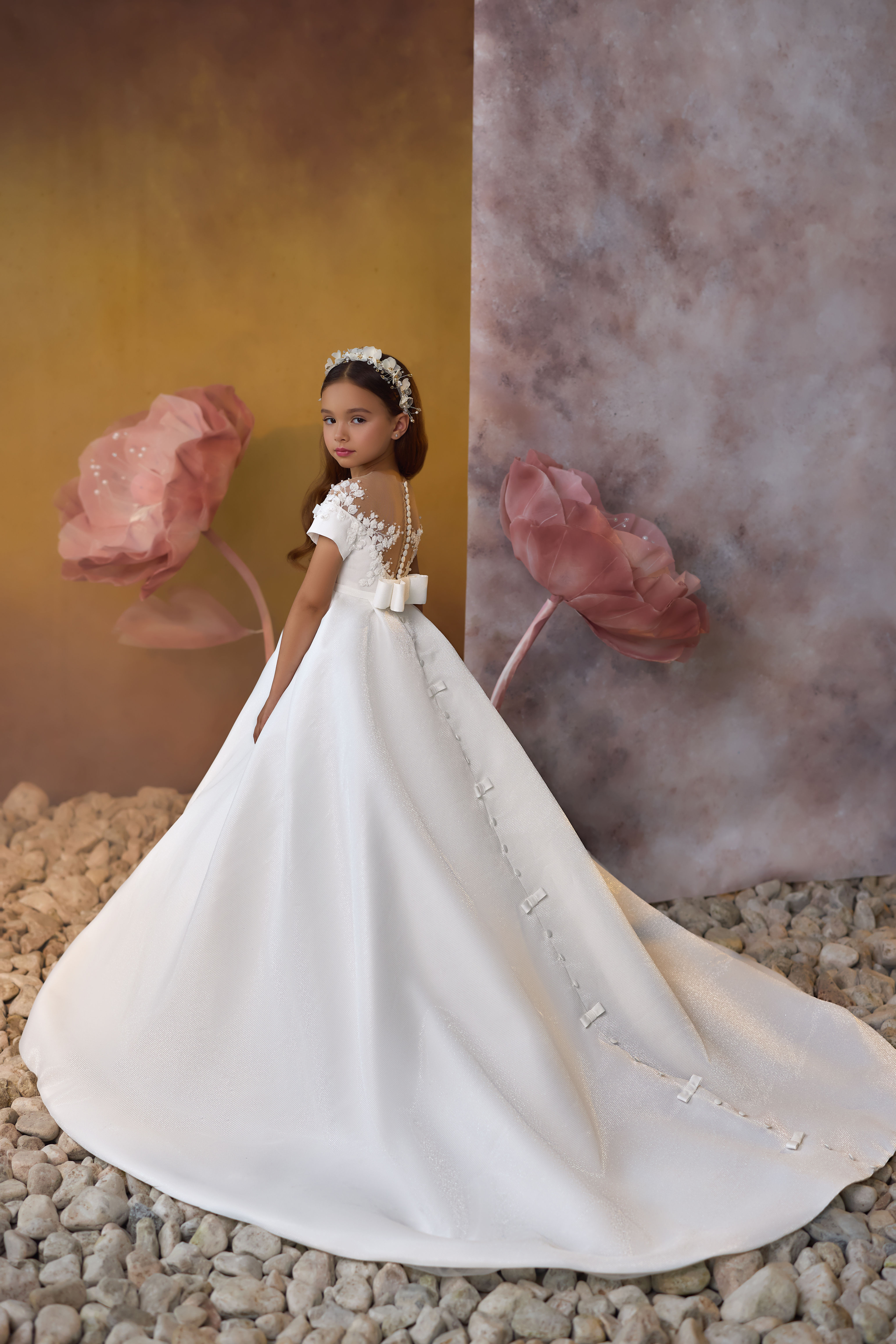 white satin communion dress with mesh floral detailing on bodice, embellished waistline and pleated skirt with train