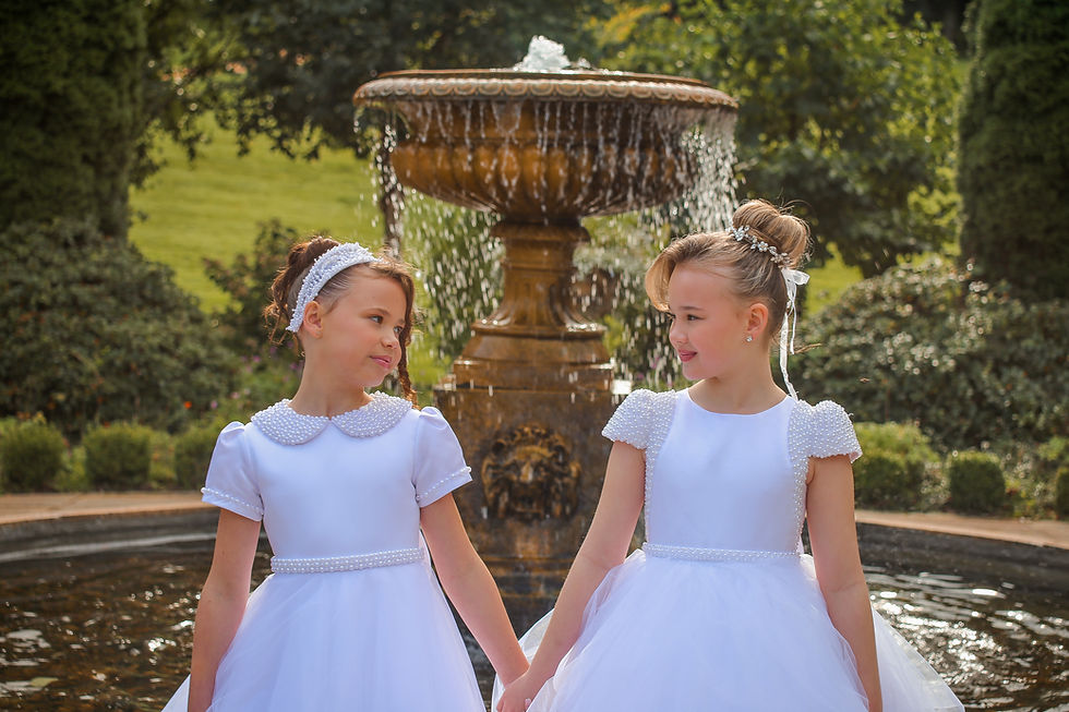 Girls wearing Crystal and Pearl communion dresses with pearl and glass beading.