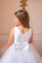 Thumbnail: back view of crystal and pearl boutique holy communion dress with satin bodice and tulle skirt and bow at the back