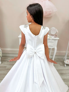 white satin holy communion dress with sleeves and beaded appliqué dress has satin skirt and satin bow at the back 