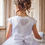 Miniature : girl wearing white crystal and pearl boutique holy communion dress with embellished pearl heart on back and sleeve