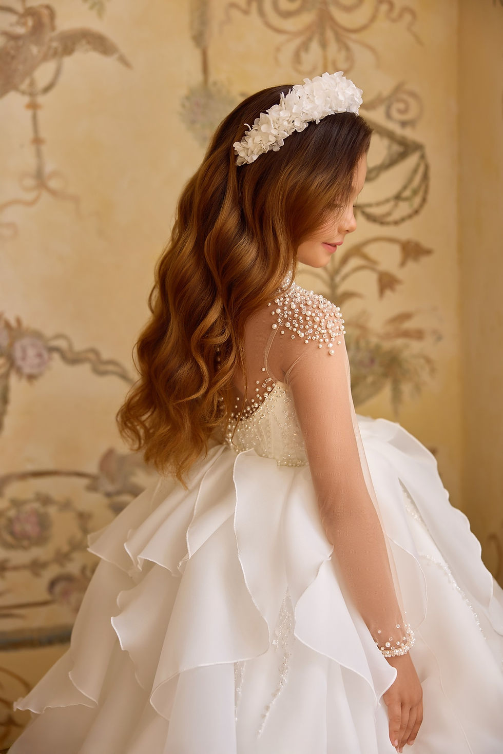 close up back view of communion dress with layered tulle skirt and pearl detailing from crystal and pearl boutique