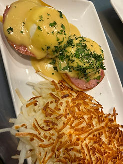 eggs benedict with hollandaise sauce served for breakfast at L & L Homestyle Café