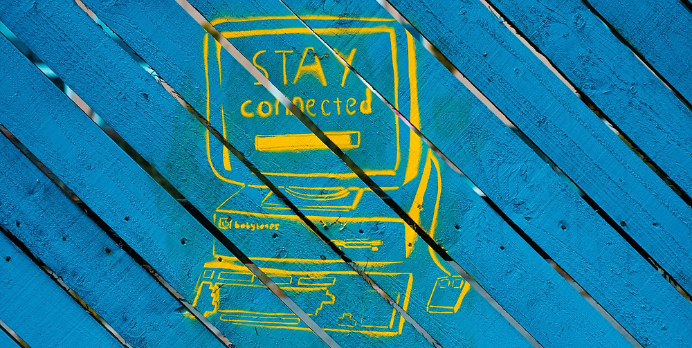 Stay connected, blue wooden board with yellow markings and quote on remote work