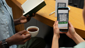 Person scanning QR Code on their mobile to make a payment.