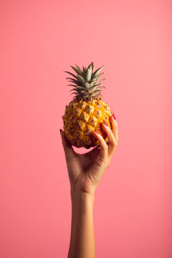 person-holding-pineapple-fruit-2940256