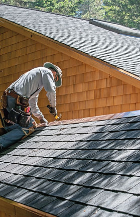 A Roofer Fixing Shingles Roof_edited.jpg