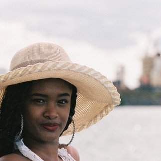 Young girl posing with hat at Caudan Waterfront