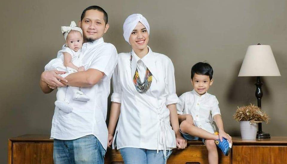 a family with a father, mother, a son and a baby daughter