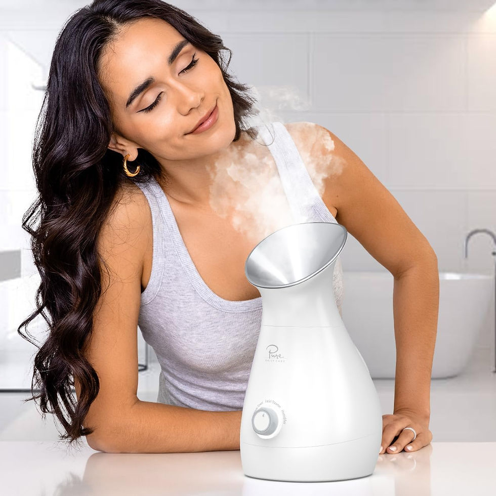 Woman enjoying facial steam in a bathroom, eyes closed, relaxed. Wearing a gray tank top. White facial steamer emitting steam.