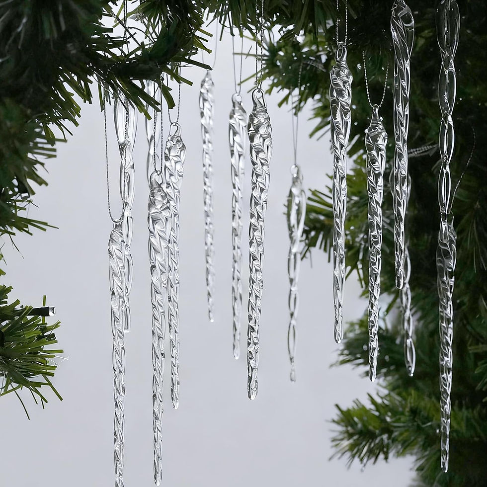 Clear glass icicles hang from green pine branches, creating a wintry scene. The background is a soft gray, enhancing the icy effect.