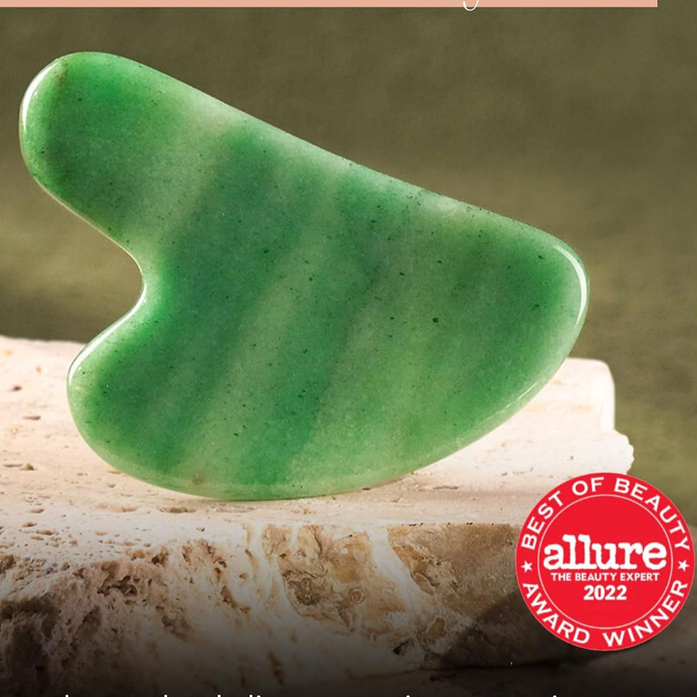 Green gua sha stone on a stone surface with a "Best of Beauty" award badge from Allure 2022. Earthy tones create a soothing vibe.