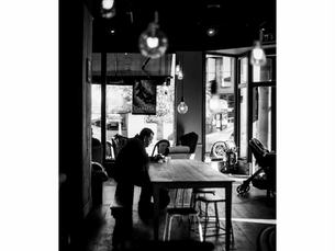 man drinking coffee in cafe