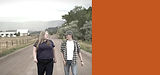 Katie Stewart walking a ranch road with a farmer