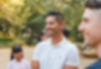 Juan Camacho smiling in a group of people at a park