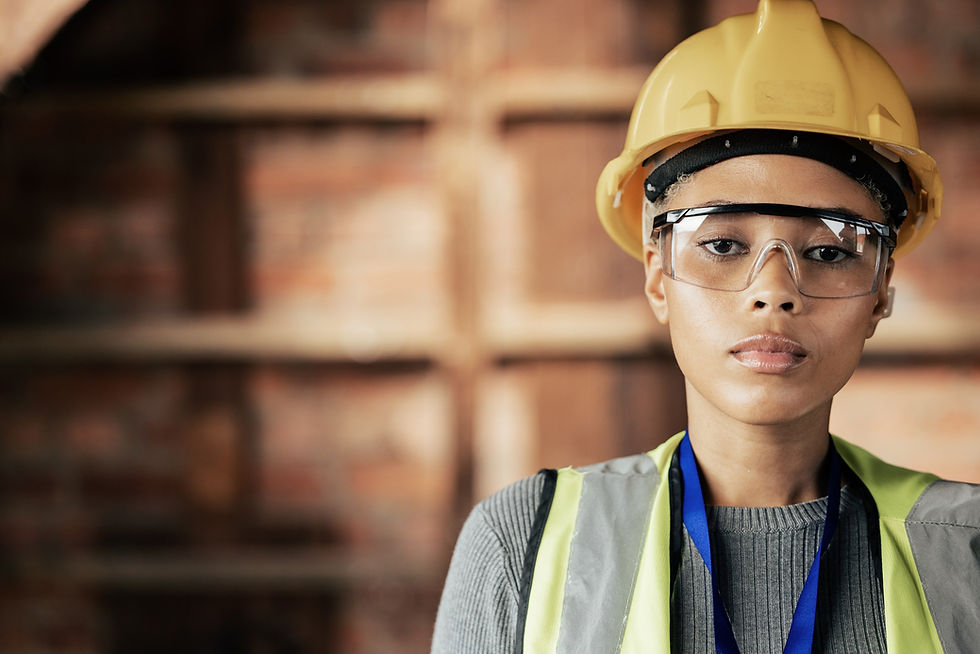 A construction worker in a hard hat and safety glasses