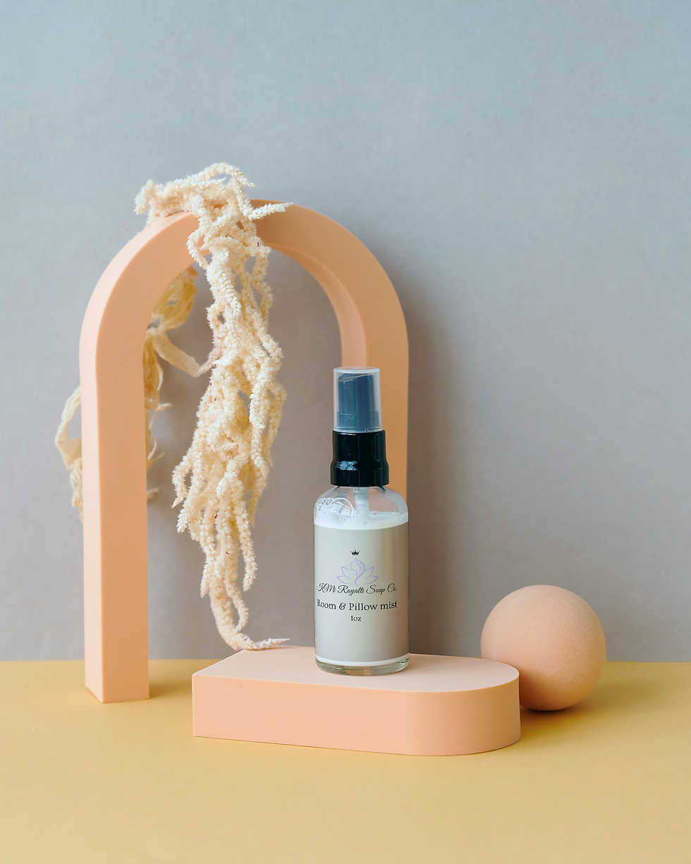 8 ounce peppermint oil room spray in eco-friendly packaging displayed beside fresh peppermint leaves.