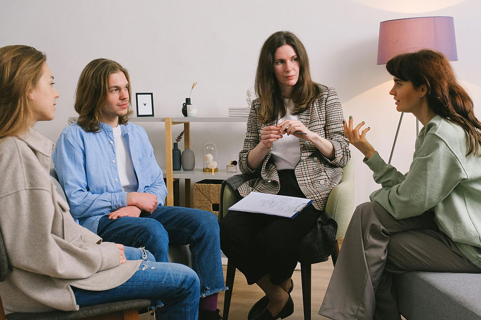 Mental health support group discussion with therapist and participants sharing experiences