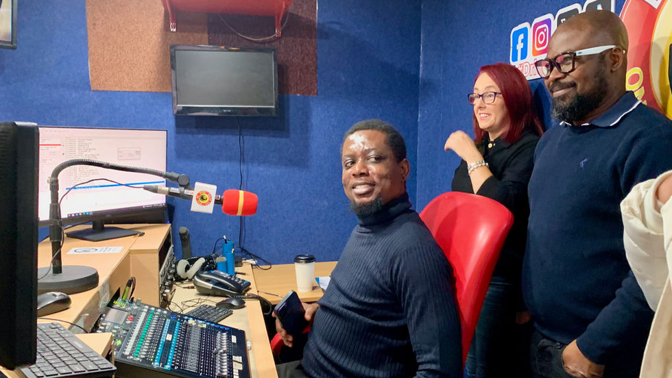 A diverse group of people in a radio studio.